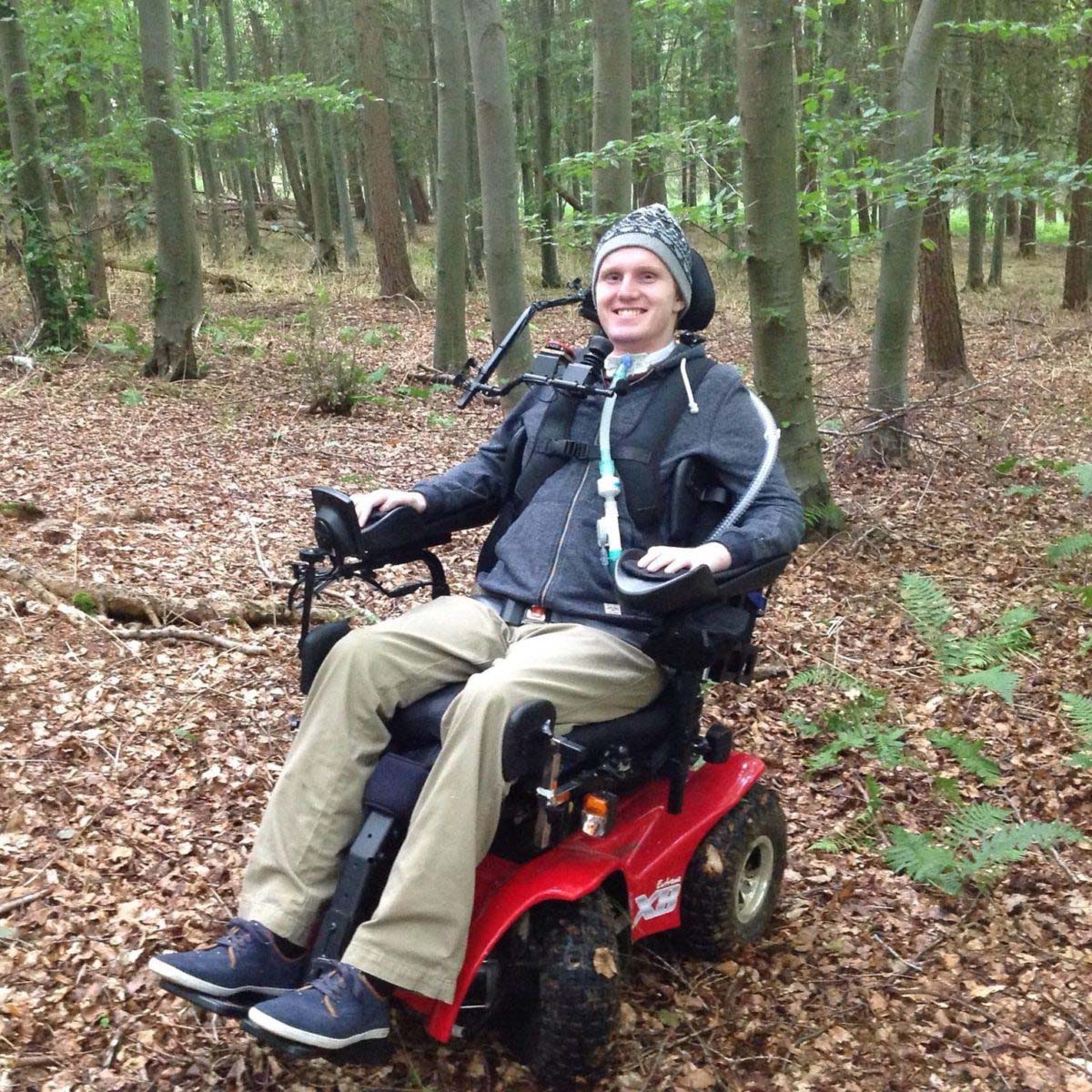 Man in wheelchair out for an adventure out in the woods