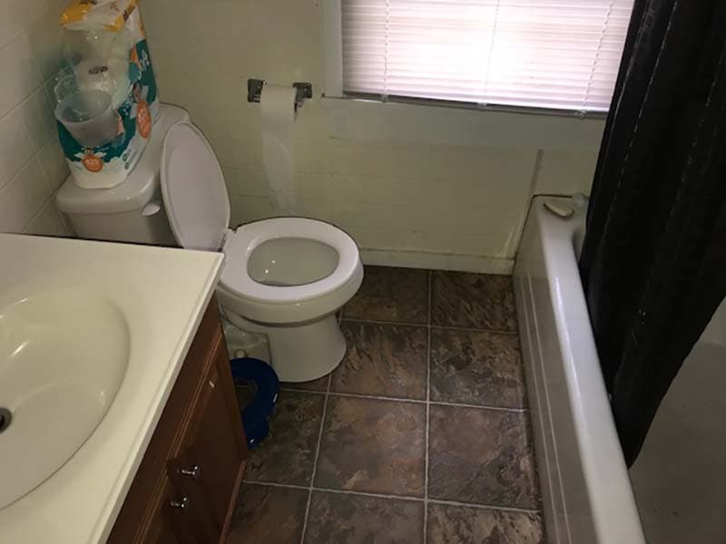 bathroom sink, toilet, and tub before a remodel by CorHome